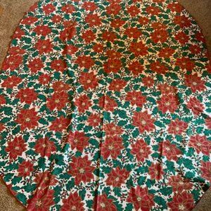 59” x 83” oval fabric tablecloth with all-over poinsettia print